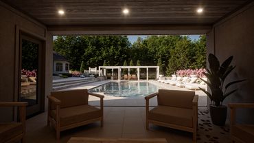 View from a cozy patio to a serene pool surrounded by lounge chairs and greenery.