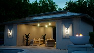 A cozy outdoor seating area with warm lighting and a fire pit at dusk.