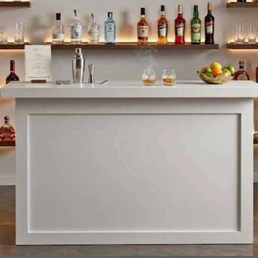 Modern indoor bar setup with bottles and glasses.