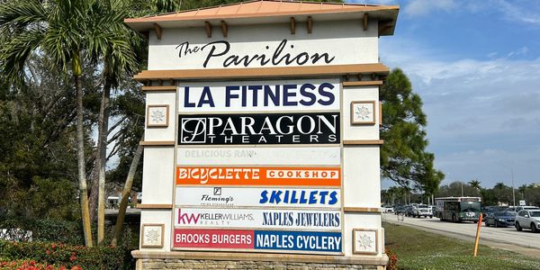 Sign showing the businesses at The Pavilion  Shoppes.