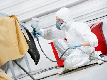 A professional applying custom paint on a car