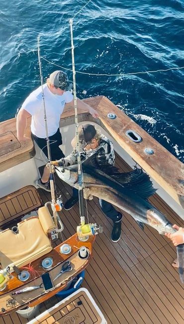 A man removing the fish from the fishing gear