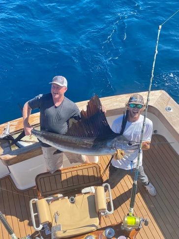 A picture of the two men holding the fish