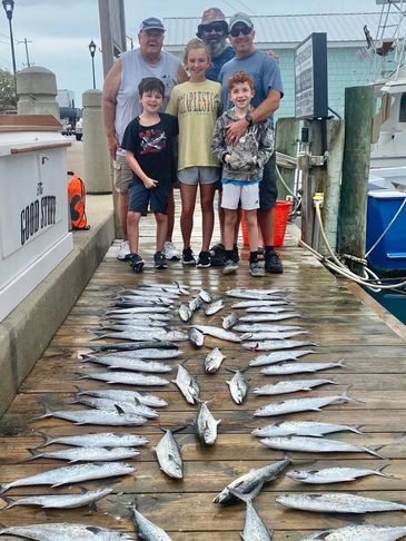 A family posing with the small fishes