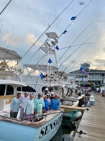 A group of friends standing on the boat 