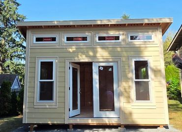 A serene landscape featuring mountains, a lake, and a clear blue sky.