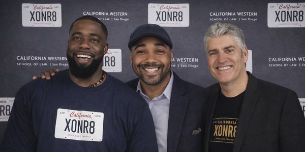 Three men smiling at a California Western School of Law event.
