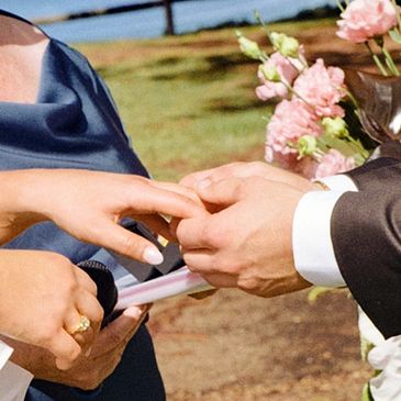 Newlywed couple exchanging rings