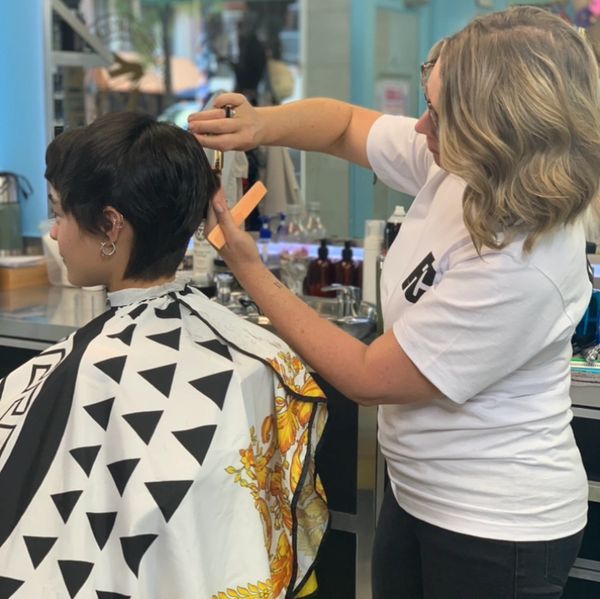A hairstylist cutting a client's hair.