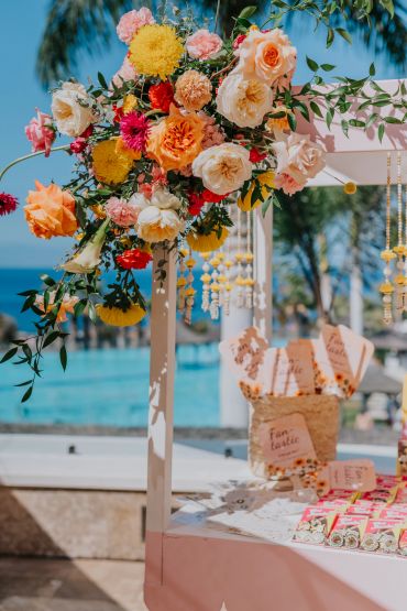 A vibrant floral arrangement at a sunny outdoor event.