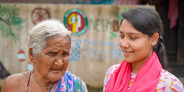 Staff member with old tribal woman