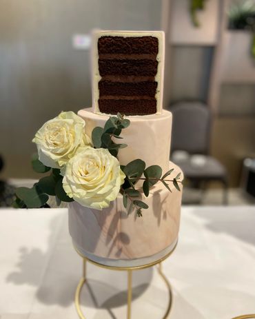 3 tier wedding cake with roses and chocolate top tier cake.