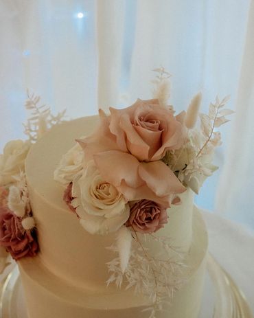 Boho styled 2 tier wedding cake with pink and white florals.