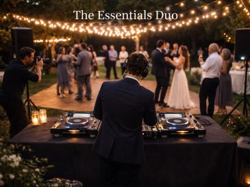 DJ playing music at an outdoor wedding reception with dancing guests.