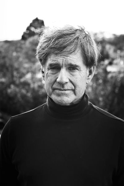 Black and white portrait of a middle-aged man with a contemplative expression.