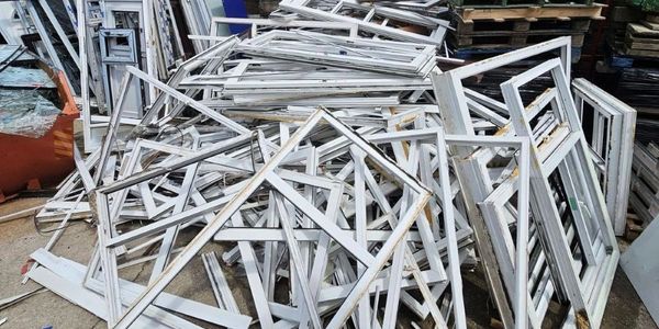 Bulk volume PVC window frames removed during refurbishment project. ready for uPVC recycling. 