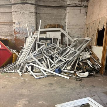 Pile of uPVC window frames from Trade PVC window frame collection from Oldham, Manchester