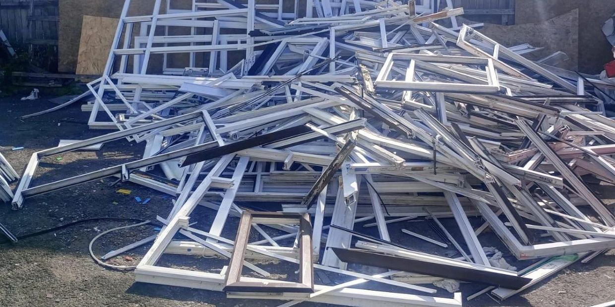 Trade uPVC window frames stacked on site for scheduled recycling collection in the North west