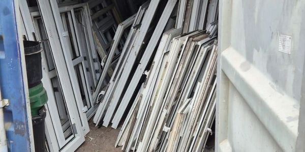 Post Consumer window frames ready for collection and recycling in Warrington 