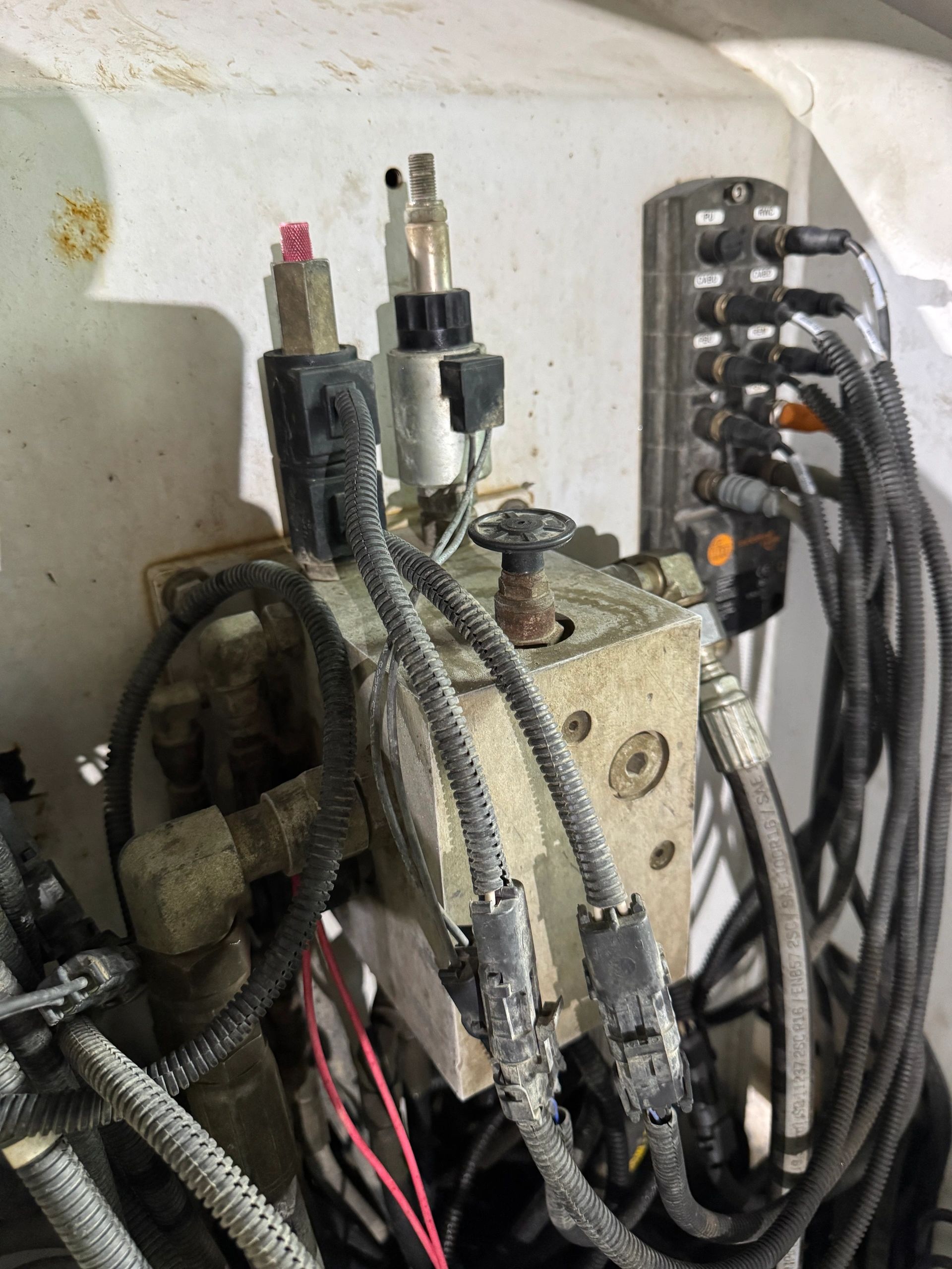 Close-up of industrial wiring and connectors inside a machine.