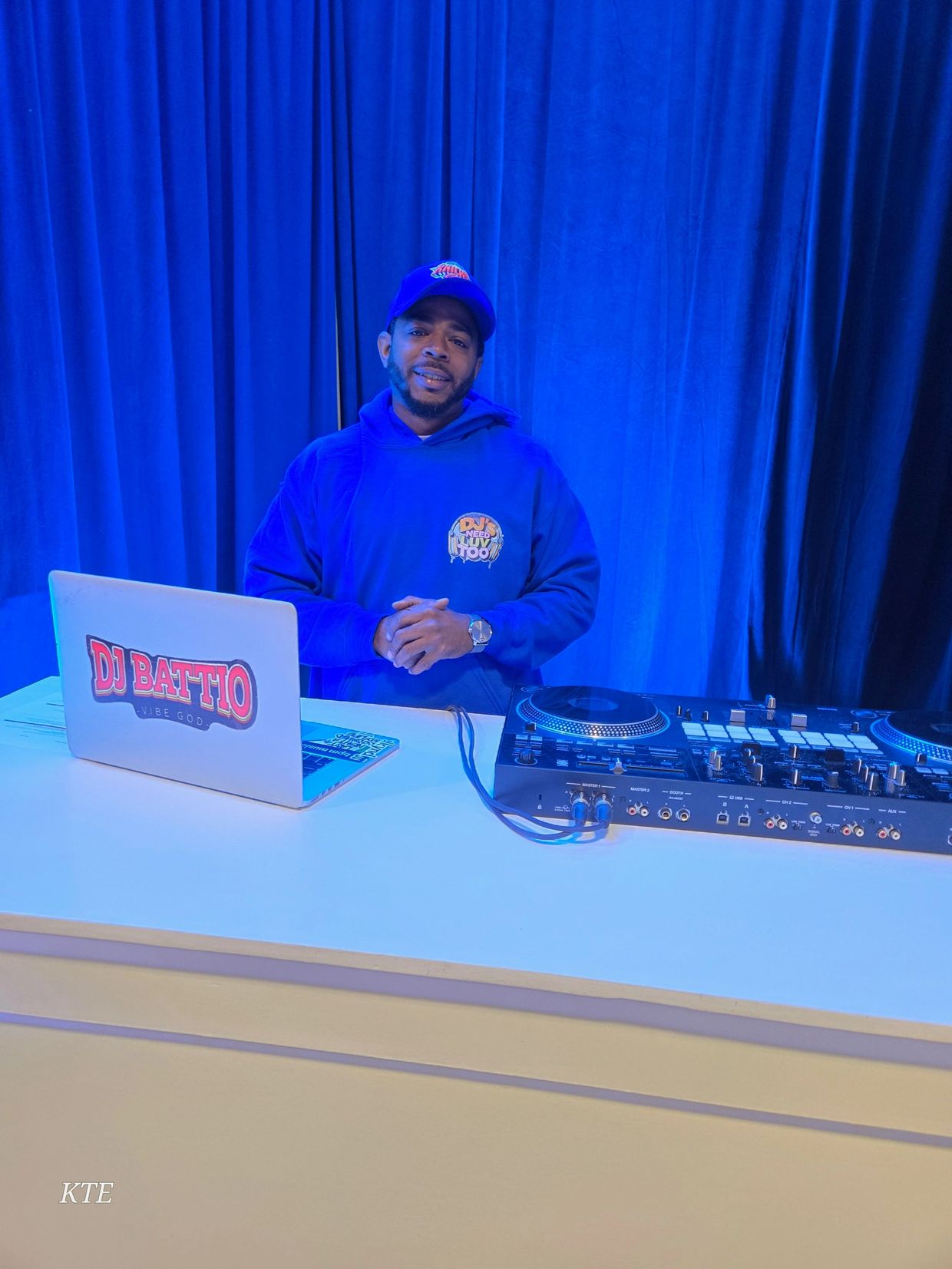DJ Battio behind the booth at a corporate conference