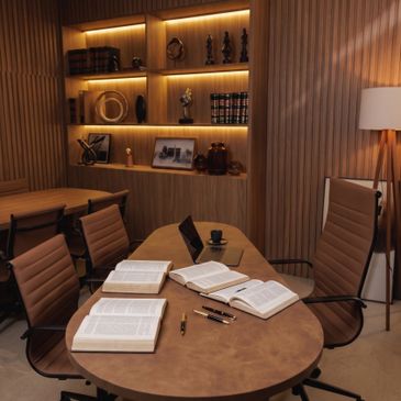 Modern study room with wooden furniture and open books on the table.