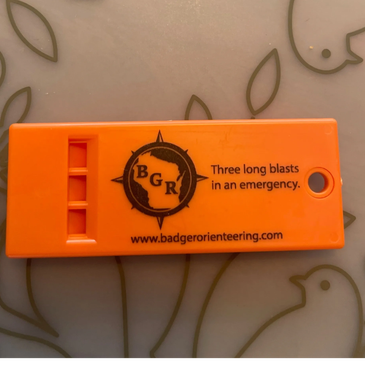 Orange whistle with emergency signal instructions from Badger Orienteering.