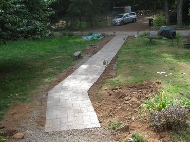 Concrete paver walkway 60' in length. Base prepared with compacted gravel and sand. 