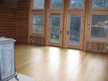 Solid wood T&G wood floor installed in an addition to a log home.