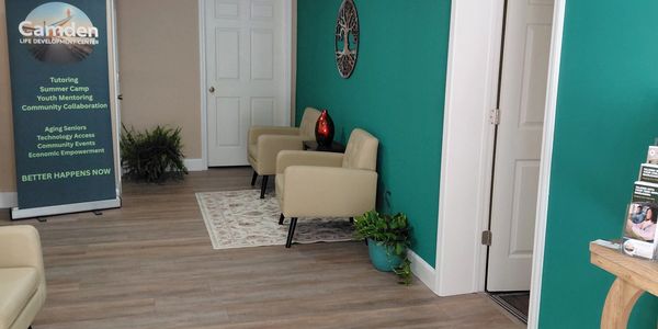 Reception area of Camden Life Development Center with chairs and banner.