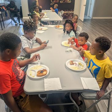 Kids eating together at a dining table.