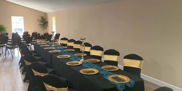 Elegant black and gold banquet table setup.