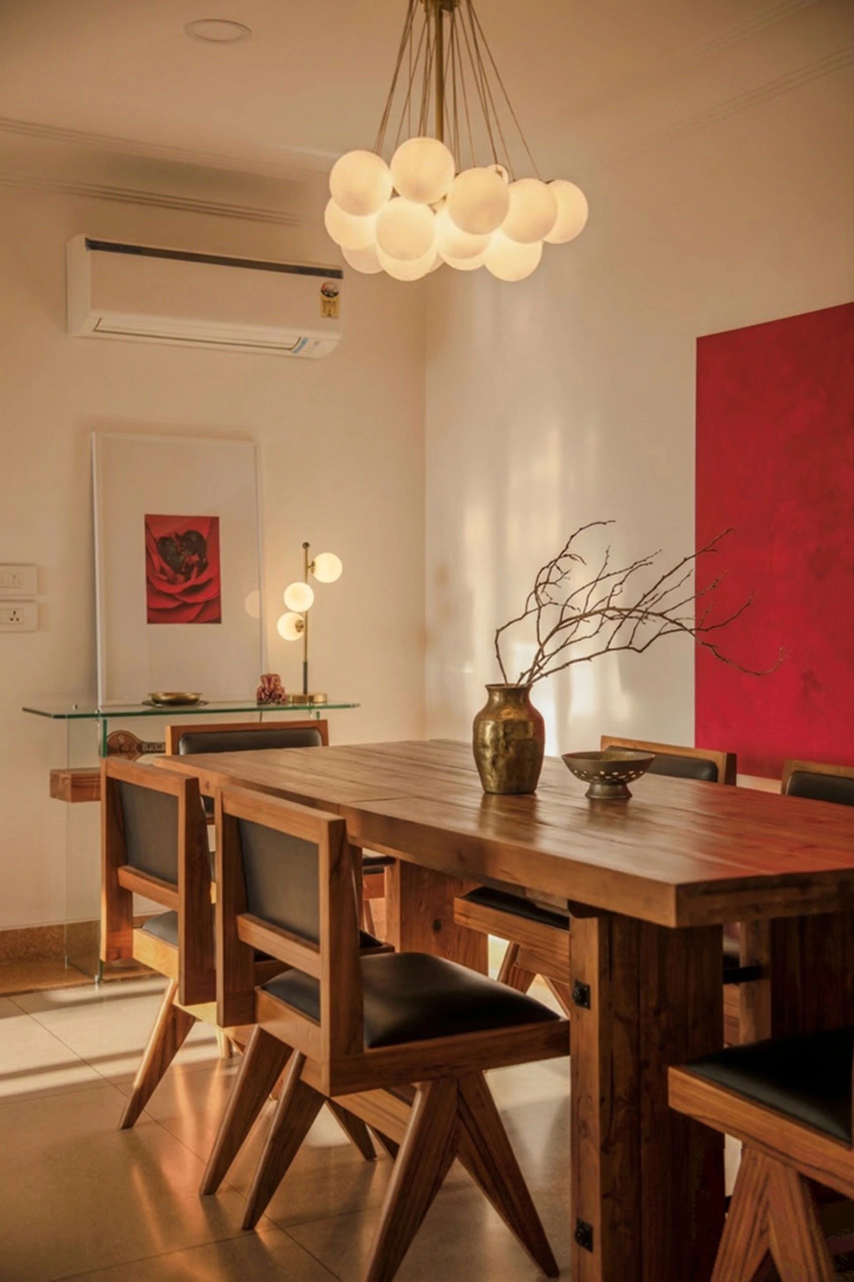 Warm dining room with wooden furniture and modern lighting.