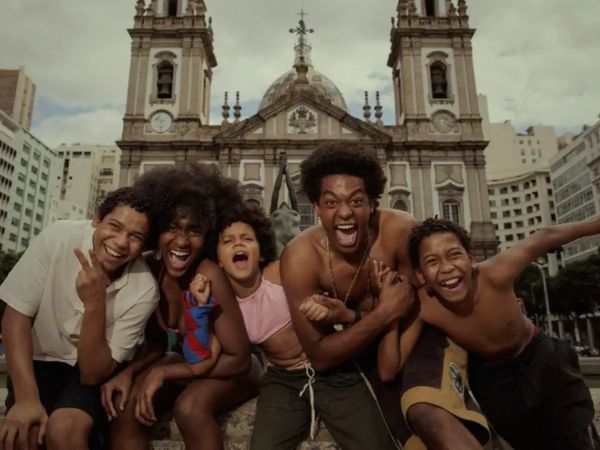 Five joyful friends posing energetically in front of a historic church.