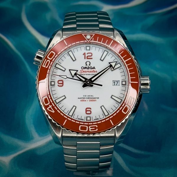 Omega Seamaster wristwatch with a red bezel and white dial.
