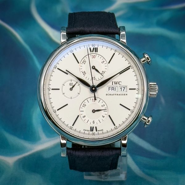 Elegant IWC wristwatch with white dial and black leather strap.
