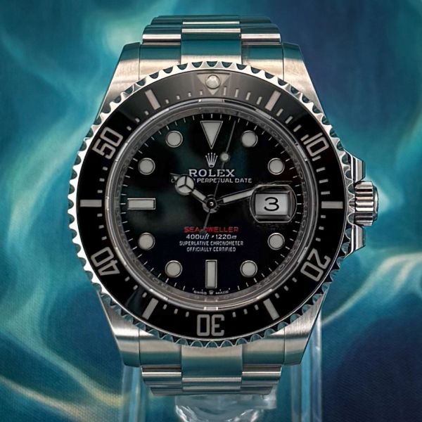 Close-up of a Rolex Sea-Dweller watch with a black dial and stainless steel bracelet.