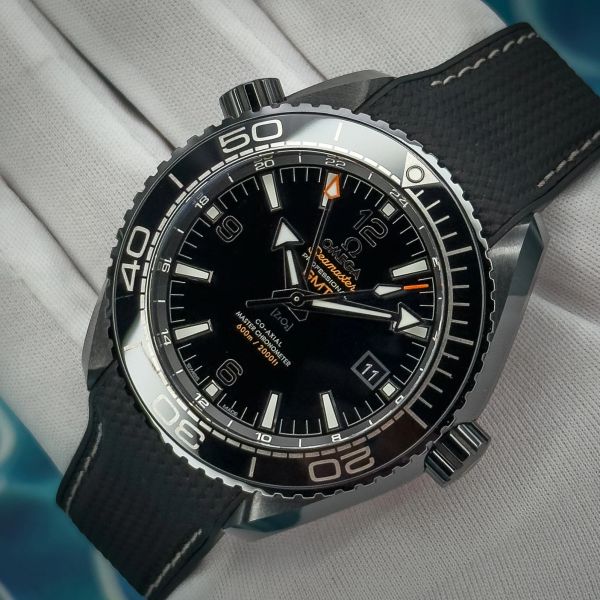 Close-up of a black Omega Seamaster Planet Ocean wristwatch.