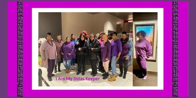 A group of women in purple and black posing together indoors.