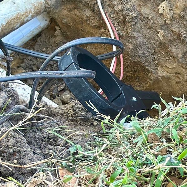 Locating underground landscape lighting wire for professional repair by Wandering Soul Services.