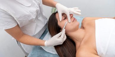 professional esthetician providing a dermaplaning treatment