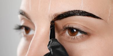 eyebrow staining solution being applied to clients eyebrow