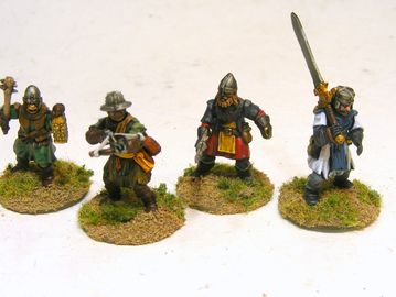 Painted medieval miniature warrior figures on grass-textured bases.