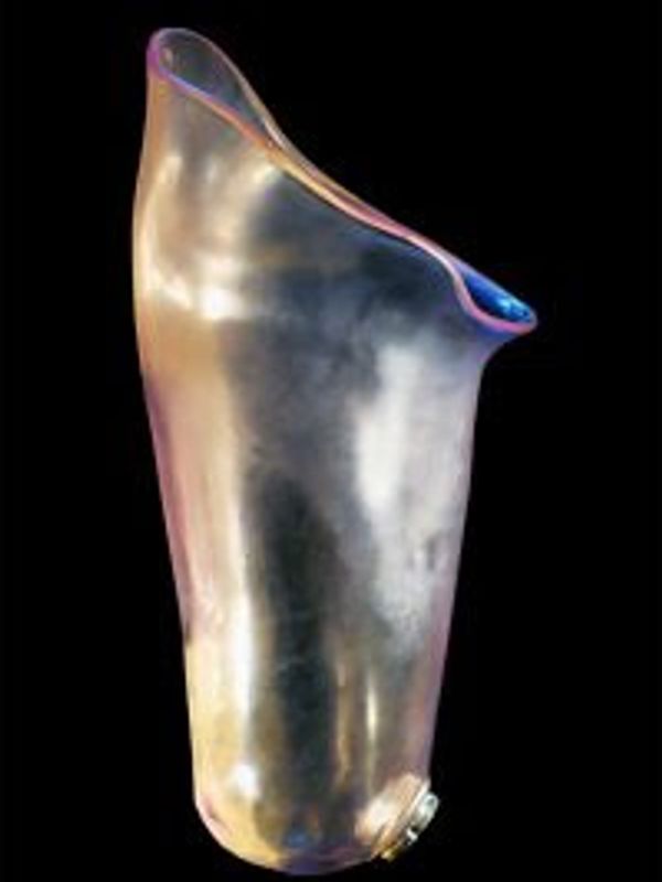 A translucent, iridescent vase with an irregular shape against a black background.