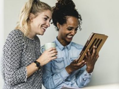 Two women looking at a computer tablet