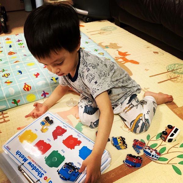 Toddler having some screen free quiet playtime with Tiny Miracles Busy book in Singapore.
