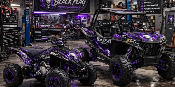 Custom black and purple off-road vehicles in a workshop.