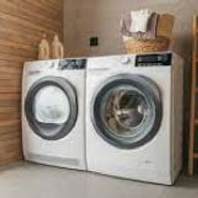 Modern front-load washer and dryer in a cozy laundry room.
