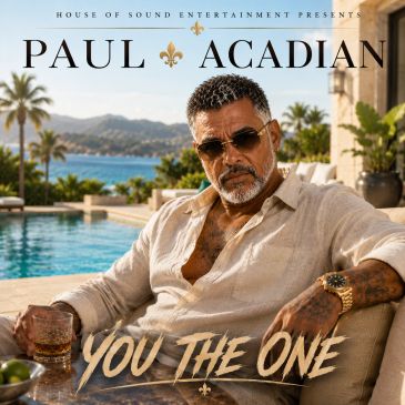 Artist Paul Acadian relaxes by a pool with a drink.