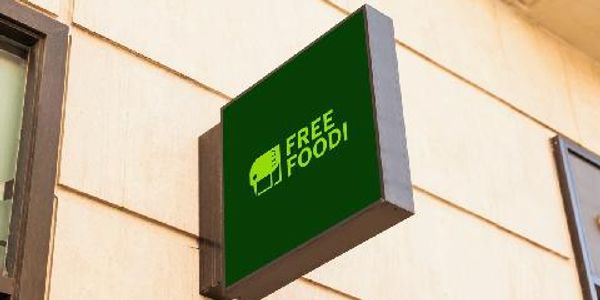 Signboard with 'Free Food!' text outside a building.